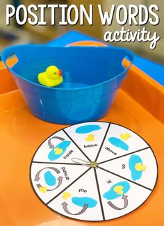 an orange table with a blue bucket and yellow rubber ducky toy on it, reading position words activity