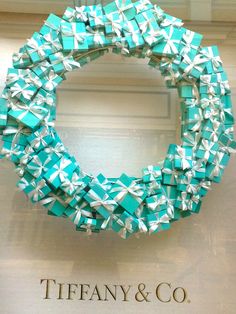 the tiffany & co logo is displayed behind a wreath made out of blue and white boxes