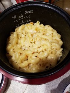 a bowl filled with macaroni and cheese on top of a table