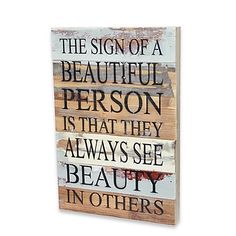 a wooden sign that says the sign of a beautiful person is that they always see beauty in others