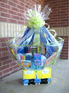 a basket filled with school supplies sitting in front of a brick wall