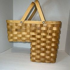 a wooden basket sitting on top of a shelf