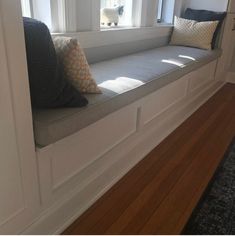 a window seat with two pillows on it