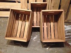 three wooden crates sitting on top of pallets