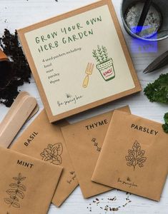 four seed packets sitting on top of a table next to some plants and dirts