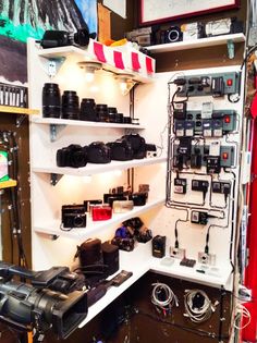 a room filled with lots of different types of cameras and electronics on shelves next to each other