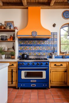 a blue stove top oven sitting inside of a kitchen