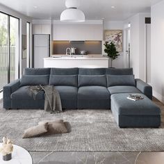 a living room filled with furniture and a large window next to a wall mounted oven