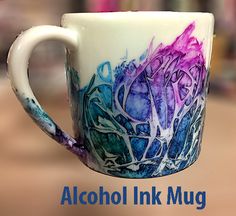 a coffee cup with alcohol ink on it