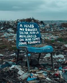 a blue chair sitting on top of a pile of trash