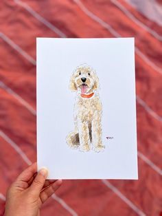 a person holding up a card with a drawing of a dog