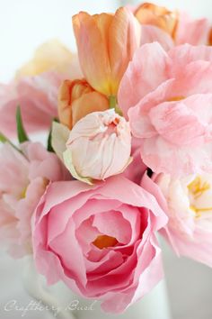 pink and yellow flowers in a white vase