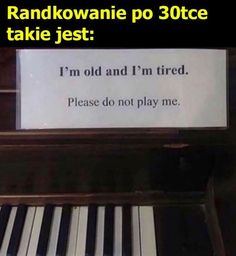 a piano with a sign on it that says, i'm old and i'm tired please do not play me