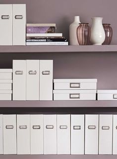 several white file cabinets and vases on shelves