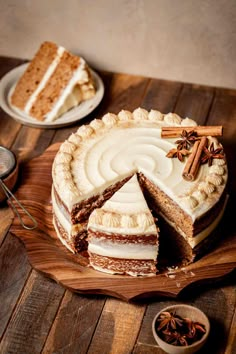 a cake on a wooden platter with one slice cut out