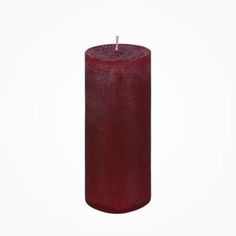 a red pillar candle on a white background