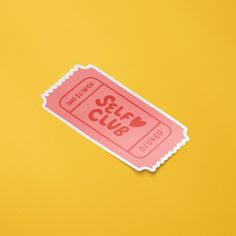 a pink sticker with the word stay club on it sitting on a yellow surface