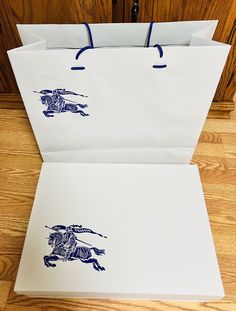 two paper bags with images of horses on them