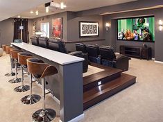 a home theater with bar seating and large screen tv