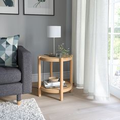 a living room with a couch, table and two pictures on the wall above it