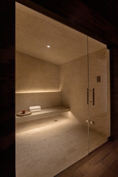 an empty room with a glass door leading to the bed and bathtub in it