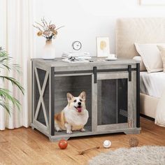 a dog in a crate on the floor next to a bed