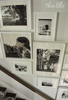 a staircase with many pictures hanging on the wall