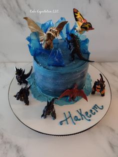 a birthday cake decorated with figurines and frosting