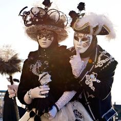 two people dressed up in costumes and masks