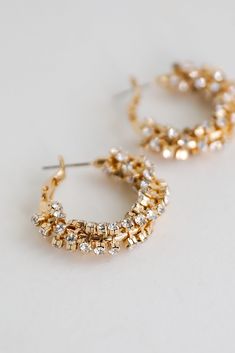 Elevate your evening with the help of the Bianca Gold Rhinestone Hoop Earrings! These chic earrings feature a lever back with a rhinestone hoop design. Style the Bianca Earrings with anything from dresses to denim for an elevated look! Gold Plated Hoop Rhinestones Lever Back One Size | Length 1” Metal Hoop Earrings With Sparkling Stones For Wedding, Crystal Hoop Earrings With Rhinestones, Elegant Small Hoop Crystal Earrings, Sparkling Hoop Crystal Earrings For Wedding, Small Crystal Hoop Earrings For Party, Party Small Hoop Crystal Earrings, Sparkling Hoop Crystal Earrings, Sparkling Crystal Hoop Earrings, Party Hoop Crystal Earrings With Sparkling Stones