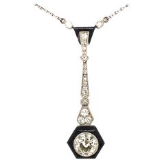 Striking historical Art Déco pendant necklace with diamonds, onyx and black enamel. Delicately handcrafted in white gold and platinum with geometric motifs set with old cut diamonds in a millegrain setting typical of the Art Déco era. The large hexagonal motif is set with a round old European-cut diamond of circa 1.3 carats (K - vs2) surrounded by black onyx. The pendant is attached to an anchor chain in platinum with push clasp and safety latch. Lenght of the pendant: 4.5 cm / 1.7 in Lenght of Art Deco Pendant Necklace, Round Diamond Pendant, Enamel Art, White Victorian, Anchor Chain, Art Deco Pendant, Onyx Jewelry, Geometric Motifs, Art Deco Necklace