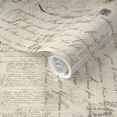 an old fashioned wallpaper with writing on it and a rolled paper roll in the foreground