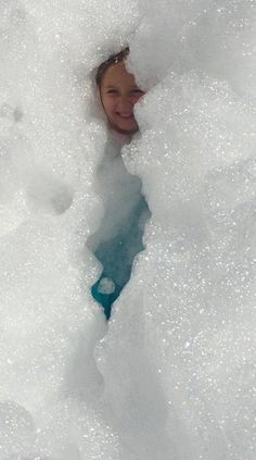 a young boy is playing in the snow