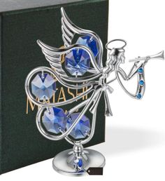 a blue crystal angel figurine sitting on top of a book