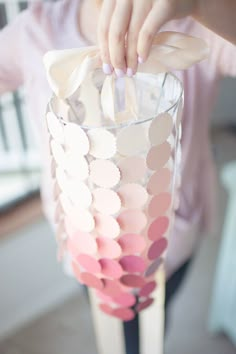 a glass vase filled with lots of pink and white confetti