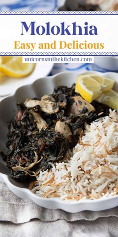 a white bowl filled with rice and greens next to lemon wedges on a table