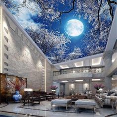 a living room filled with furniture and a sky ceiling painted to look like the moon