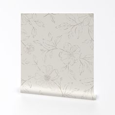 a white flowered wallpaper with silver flowers on it's side and the bottom half