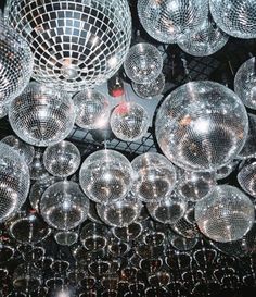 many disco balls are hanging from the ceiling