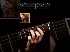 a person playing an acoustic guitar with their fingers