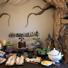 a table topped with lots of food and desserts