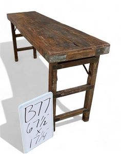 a wooden table with a sign next to it