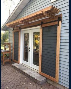 an outside patio with a wooden pergolan and sliding glass doors on the side