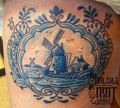 a woman's thigh with a windmill tattoo on it