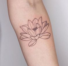 a woman's arm with a flower tattoo on it