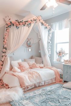 a bedroom decorated in pink and white with flowers on the bed, rugs and curtains