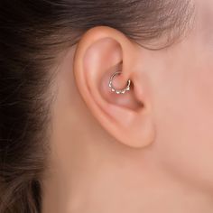 a close up of a person's ear with a ring on the middle of it