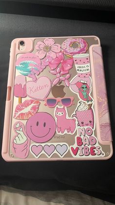 a pink ipad case with stickers on it