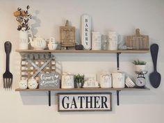 two wooden shelves filled with kitchen utensils and coffee mugs on top of each shelf