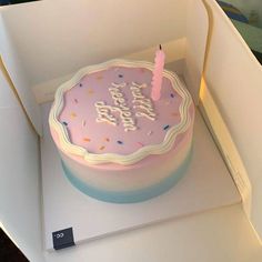 a pink birthday cake in a white box